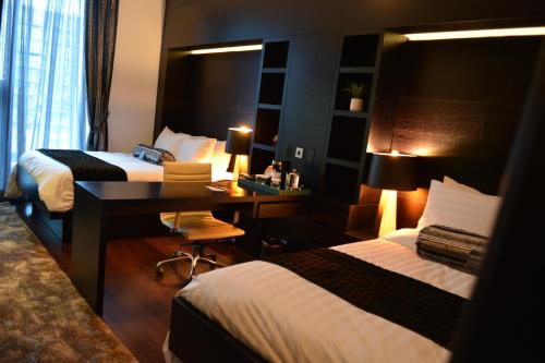 Habitación con 2 camas grandes del hotel The One Boutique