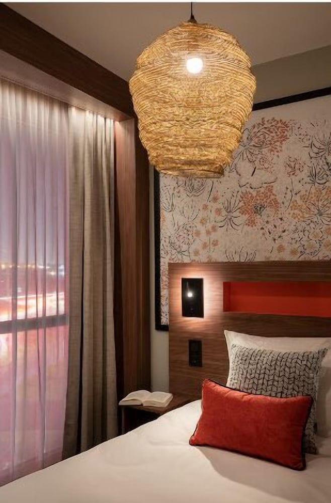 Habitación Deluxe con 1 cama doble king size, sofá cama y gran ventana acristalada del hotel Mercure Achères St Germain En Laye. Foto 4