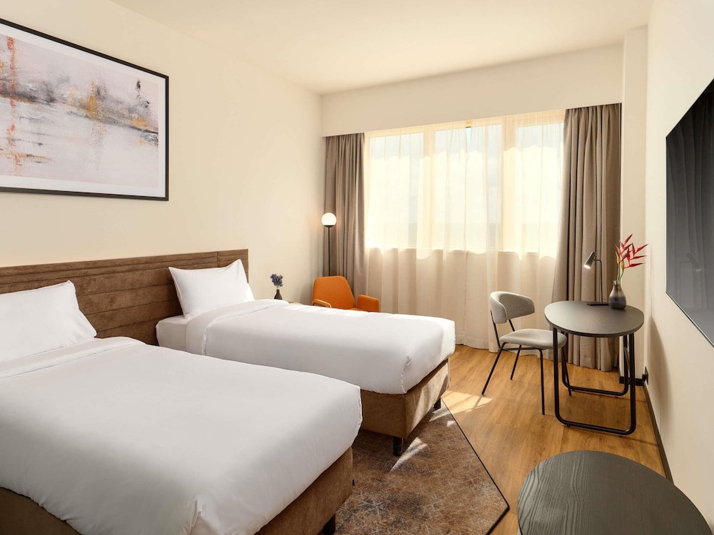Habitación estándar con dos camas individuales del hotel Novotel Zagreb. Foto 1