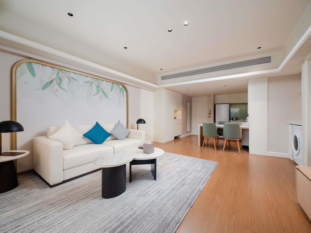 Habitación Swiss Executive con sala de estar, dormitorio y dos camas individuales del hotel Swissôtel Living Shanghai Hongqiao