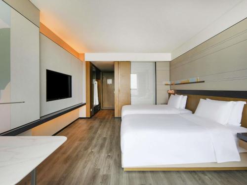Habitación Doble Deluxe con vistas a la ciudad - 2 camas del hotel Novotel Shanghai Chuansha. Foto 2
