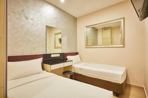 Habitación estándar con camas individuales del hotel Ibis Budget Singapore Mount Faber (sg Clean). Foto 3
