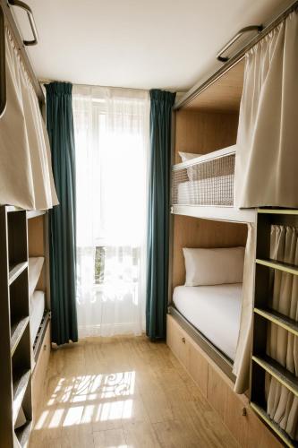 Cama en habitación femenina compartida de 4 camas del hotel The Playce and Bar By Happyculture. Foto 10
