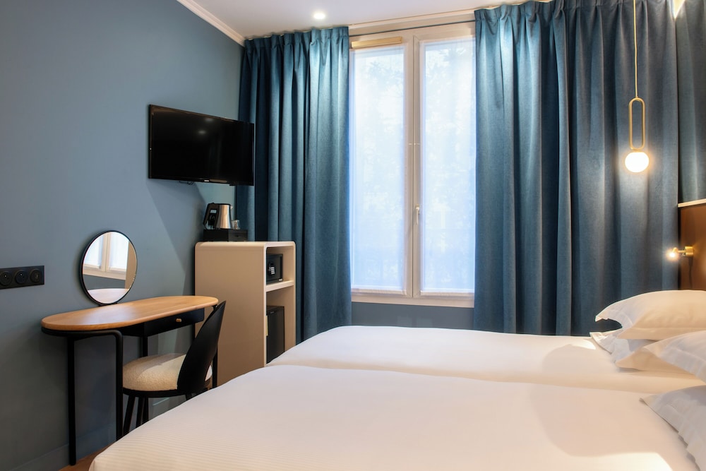 Habitación con 2 camas individuales del hotel Arc Elysees. Foto 1