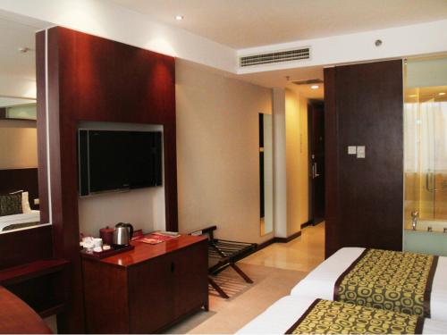 Superior twin bed room del hotel Mercure Wanshang Beijing. Foto 1