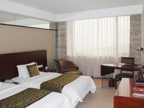 Superior twin bed room del hotel Mercure Wanshang Beijing. Foto 3