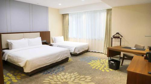 Habitación Familiar del hotel Mercure Wanshang Beijing. Foto 1