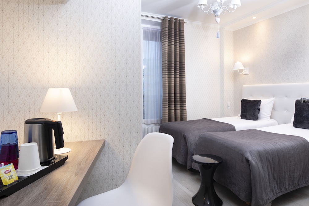 Habitación con 2 camas individuales del hotel De Geneve