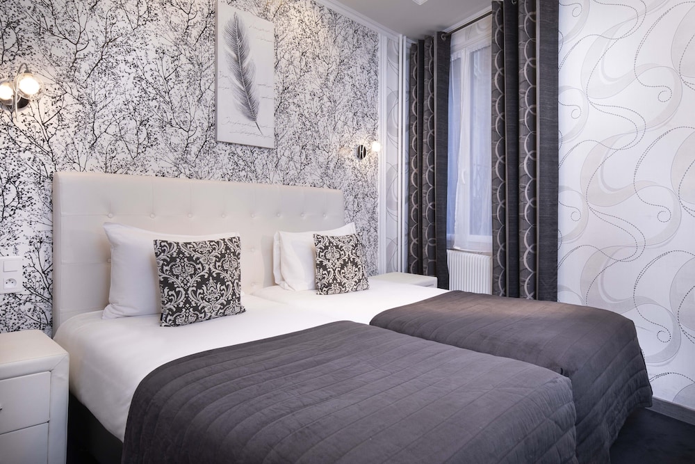 Habitación con 2 camas individuales del hotel De Geneve. Foto 1