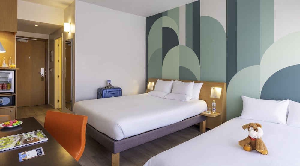 Habitación Estándar con 1 cama Queen y sofá en el edificio Plaza del hotel Novotel Madrid Campo de las Naciones. Foto 1
