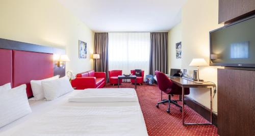 Habitación Doble Confort con sofá cama del hotel PLAZA Premium Salzburg. Foto 3
