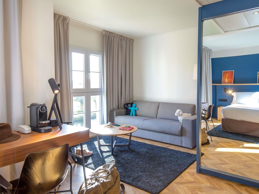 Suite Junior con 1 cama king size y sofá del hotel Mercure Chantilly Resort and Conventions. Foto 6
