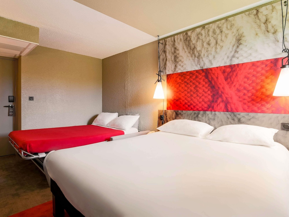 Habitación familiar con cama doble y un sofá cama del hotel Ibis Carcassonne Est La Cité. Foto 3