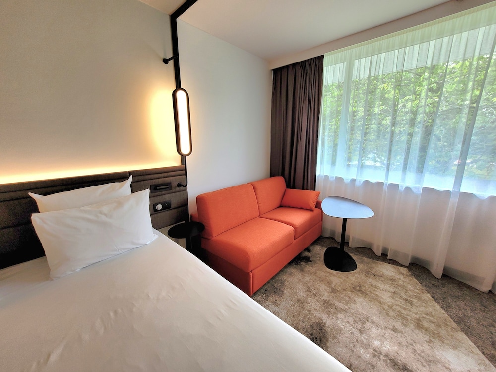 Habitación Executive con cama doble y sofá cama individual del hotel Novotel Lille Aeroport. Foto 6