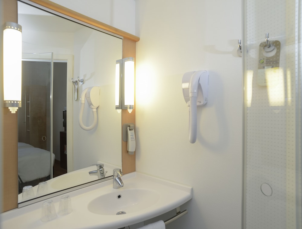 Una cama matrimonial, WiFi, televisor de pantalla plana LED y cuarto de baño con ducha del hotel Ibis Cancun Centro. Foto 1