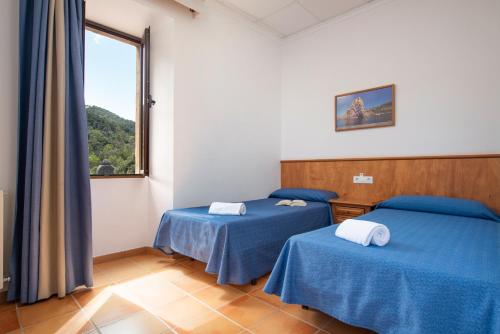 Habitación Cuádruple del hotel Hospedería Santuari de Lluc. Foto 1