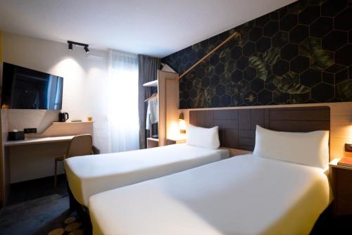 Habitación Familiar con 2 camas dobles del hotel Ibis Styles Strasbourg Nord Palais des Congrès. Foto 1