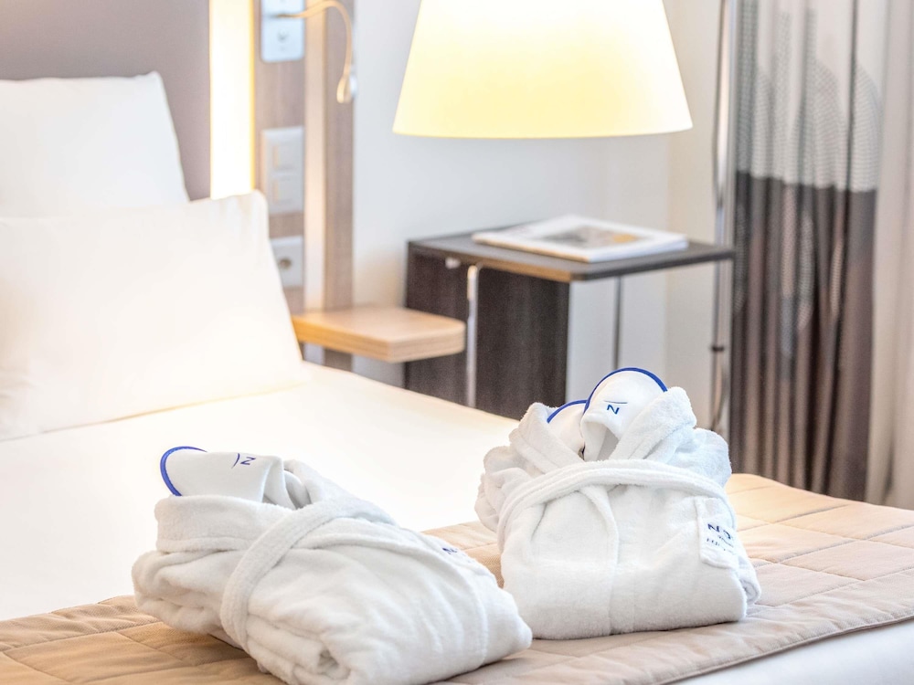Suite con una cama king size y sofá cama del hotel Novotel Lugano Paradiso. Foto 4