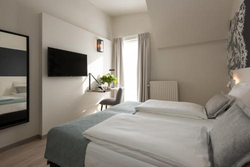 Habitación Doble con bañera del hotel Martin's Brugge. Foto 1